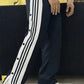 Front view of black snap pants for casual street style