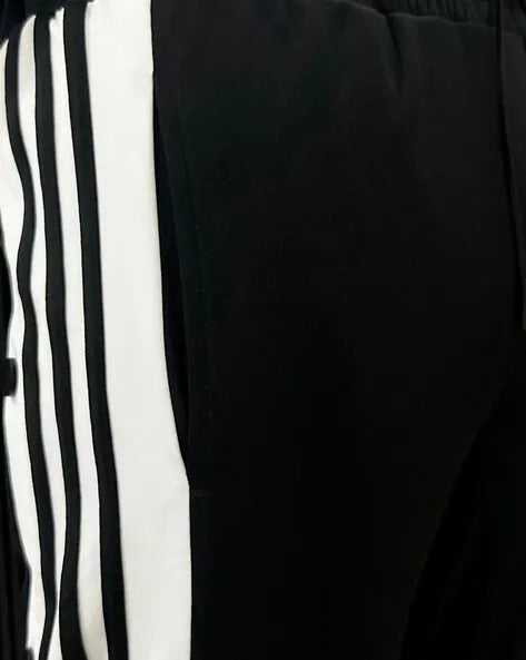 Trendy unisex snap button trousers styled with sneakers