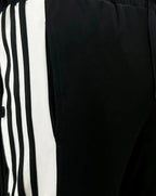 Trendy unisex snap button trousers styled with sneakers
