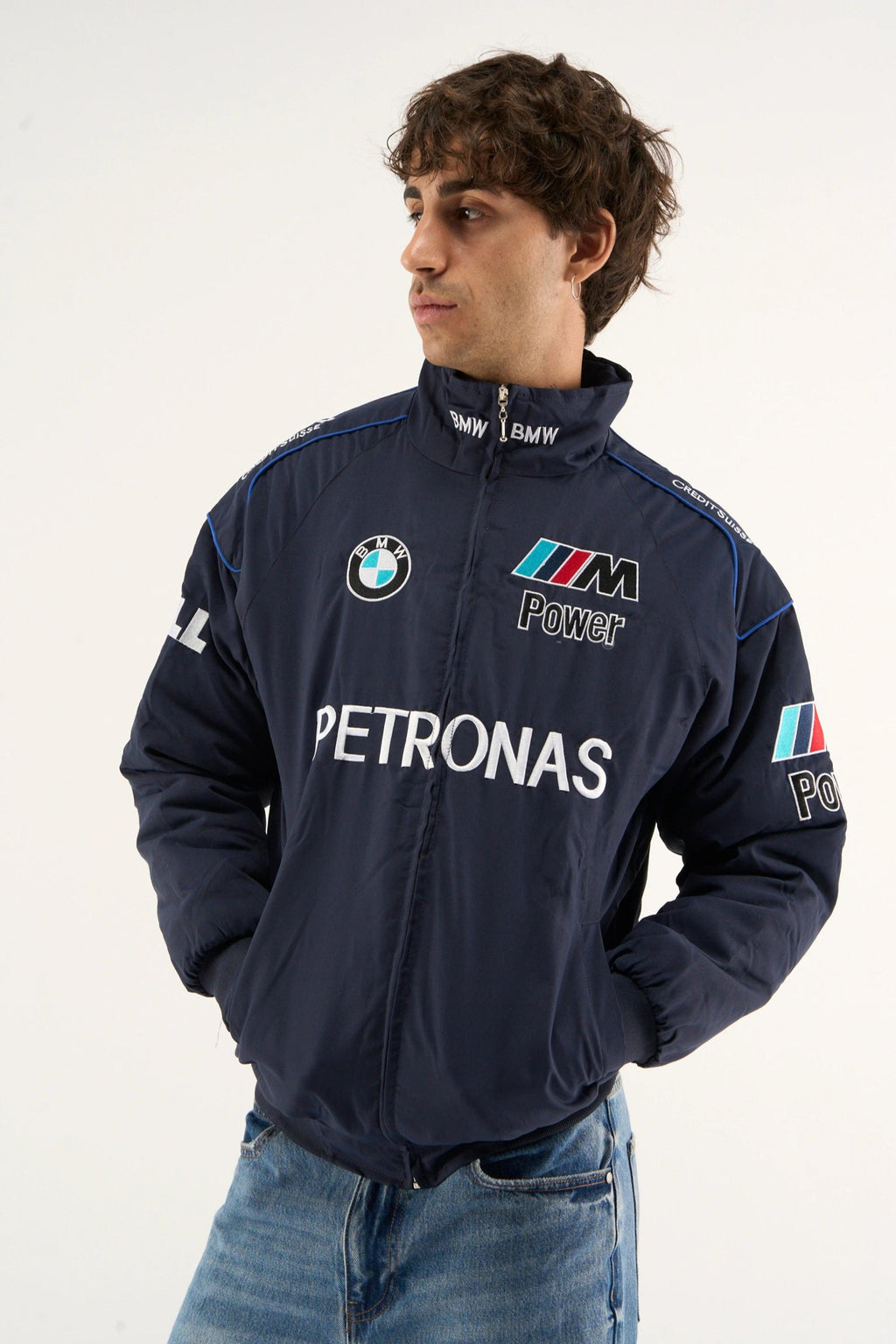Front zipped view of BMW Petronas jacket in navy parachute fabric worn by model