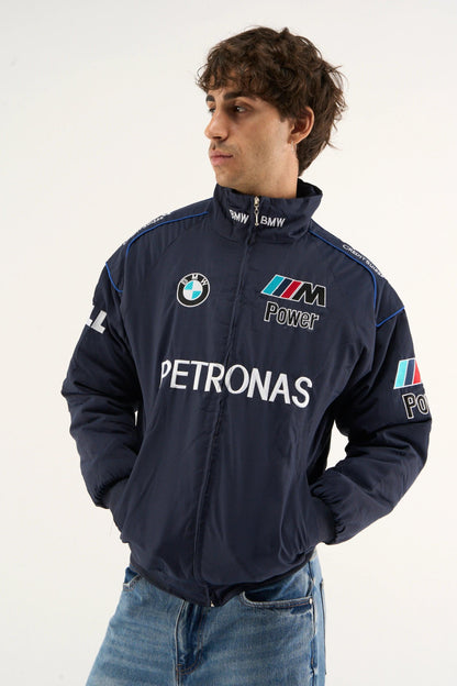 Front zipped view of BMW Petronas jacket in navy parachute fabric worn by model