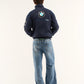 Person wearing a BMW Petronas Racing Jacket Premium Printed Designwith a BMW logo on the back, standing against a white background