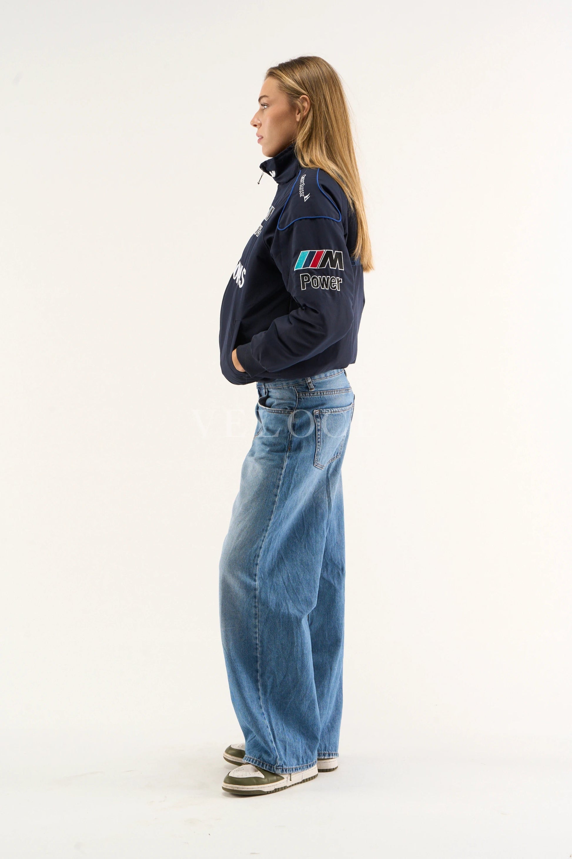 Side-angle shot of BMW Petronas bomber jacket highlighting embroidered Motorsport details