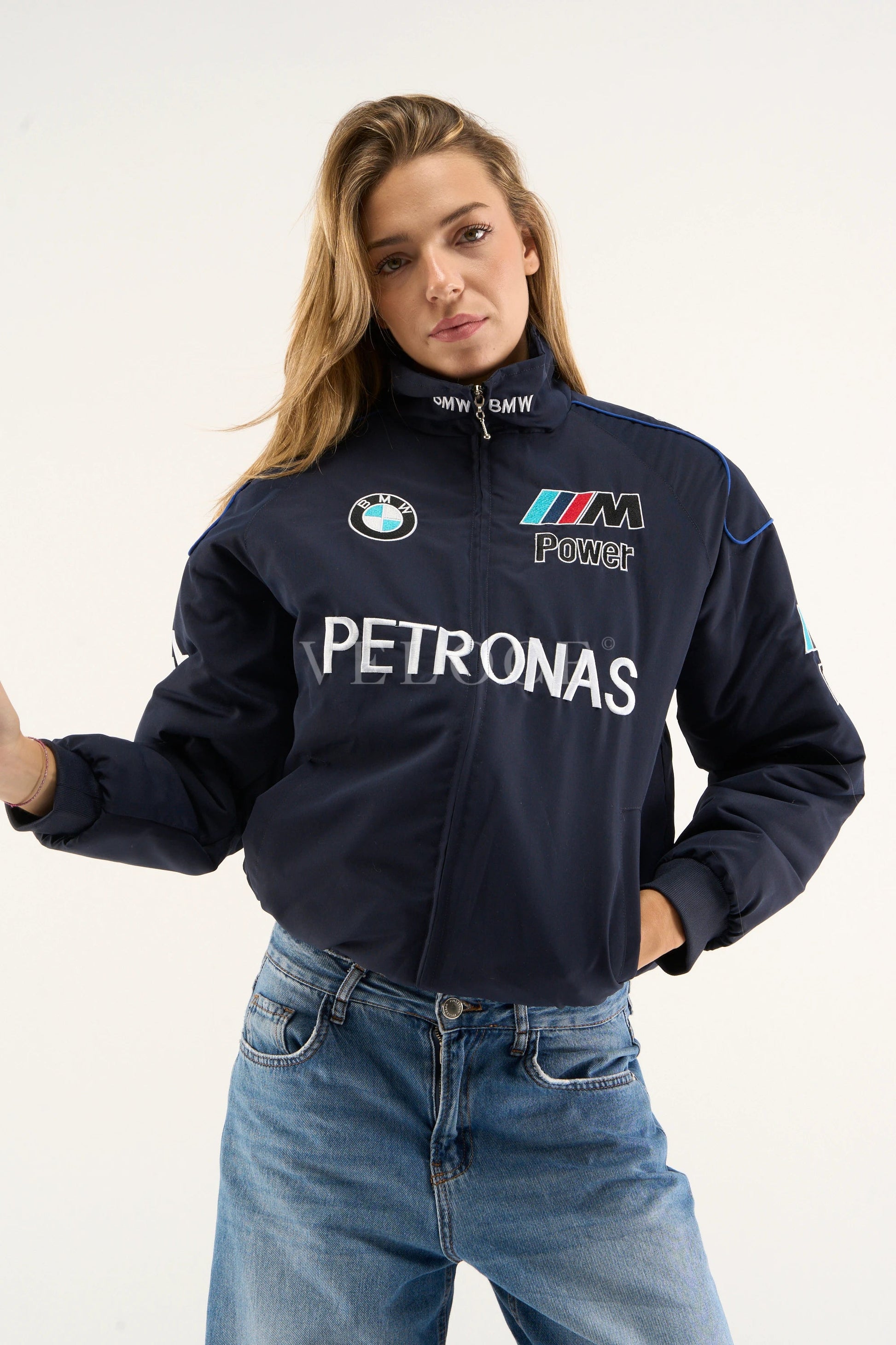 Model posing in BMW Petronas parachute jacket with hands in pockets