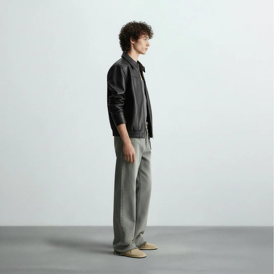 Side view of black bomber leather jacket for men and women, showcasing slim fit design and premium faux leather finish by Gigavibe