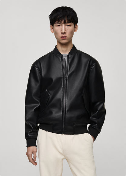 Model wearing a Premium black leather bomber jacket with classic bomber style fit on a plain background