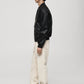 Model wearing Gigavibe Black Leather Bomber Jacket side profile