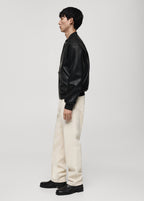Model wearing Gigavibe Black Leather Bomber Jacket side profile