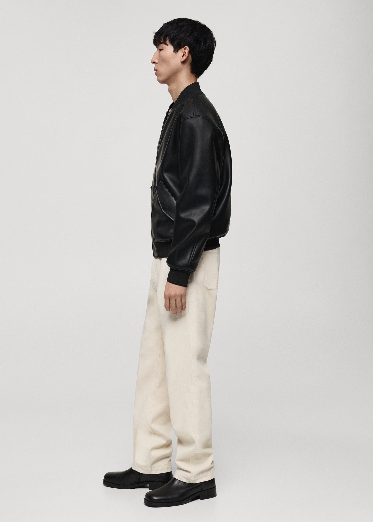 Model wearing Gigavibe Black Leather Bomber Jacket side profile