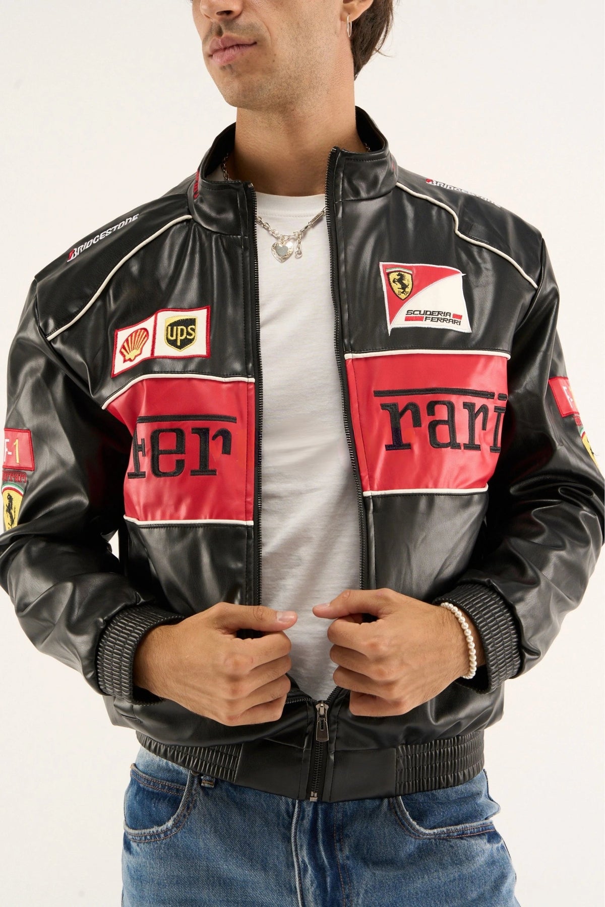 Close-up of ferrari motorsport jacket chest detailing with racing badges and premium leather craftsmanship