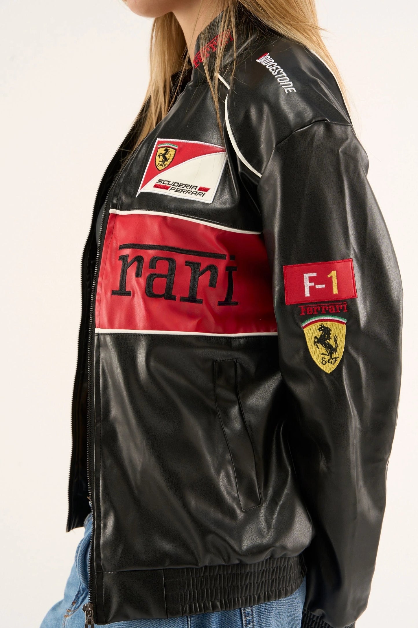 Side view of ferrari red black leather jacket showing scuderia ferrari patch, F1 sleeve detail, and premium leather texture