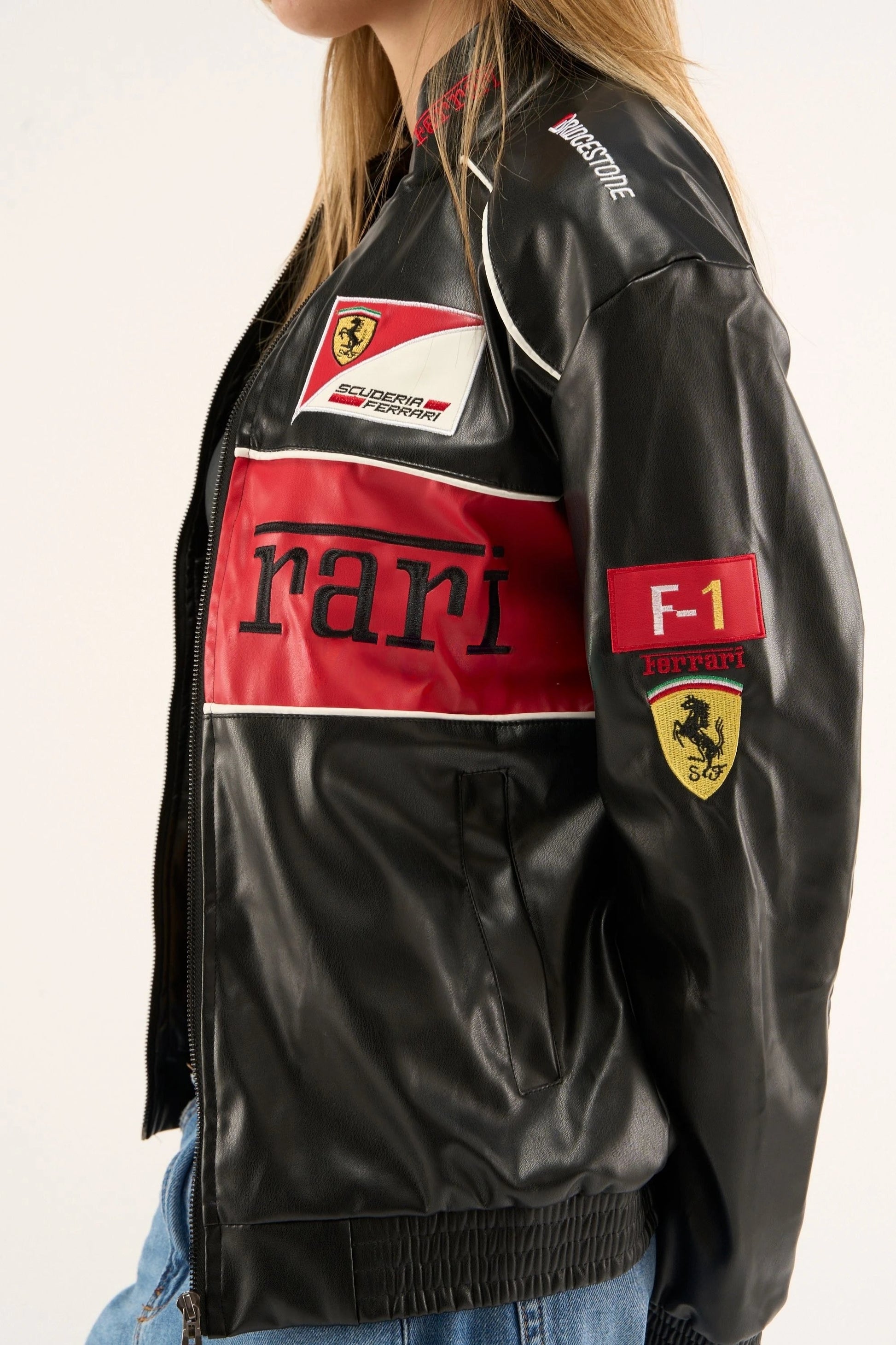 Side view of ferrari red black leather jacket showing scuderia ferrari patch, F1 sleeve detail, and premium leather texture