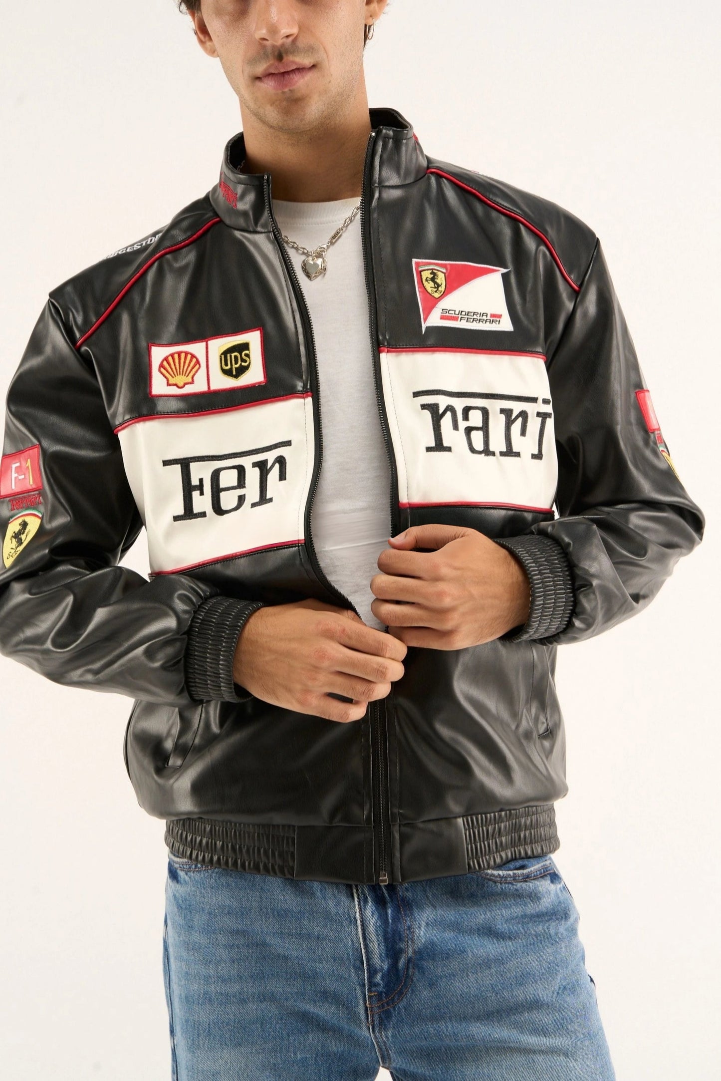 Ferrari black white racing jacket worn by male model showing Scuderia Ferrari badge and racing inspired leather finish
