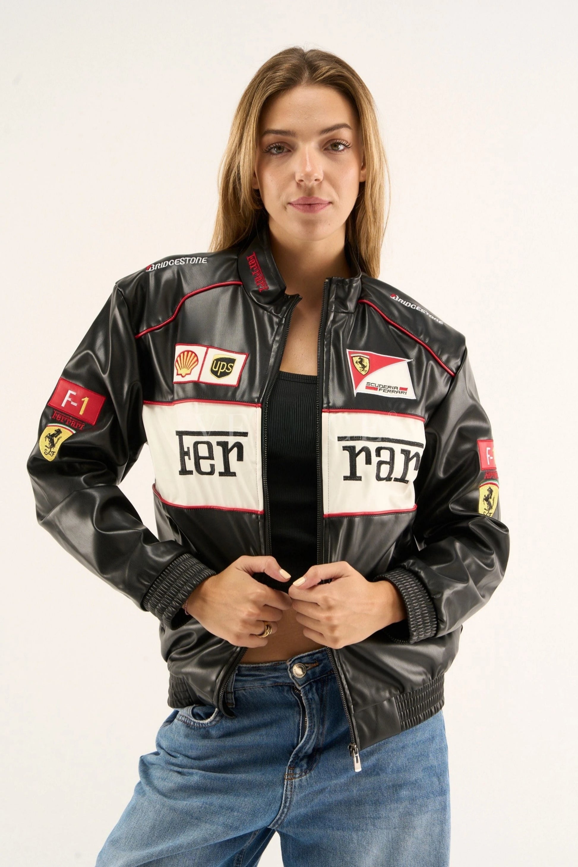 Black and white Ferrari leather jacket front view on female model featuring F1 racing patches and premium motorsport design