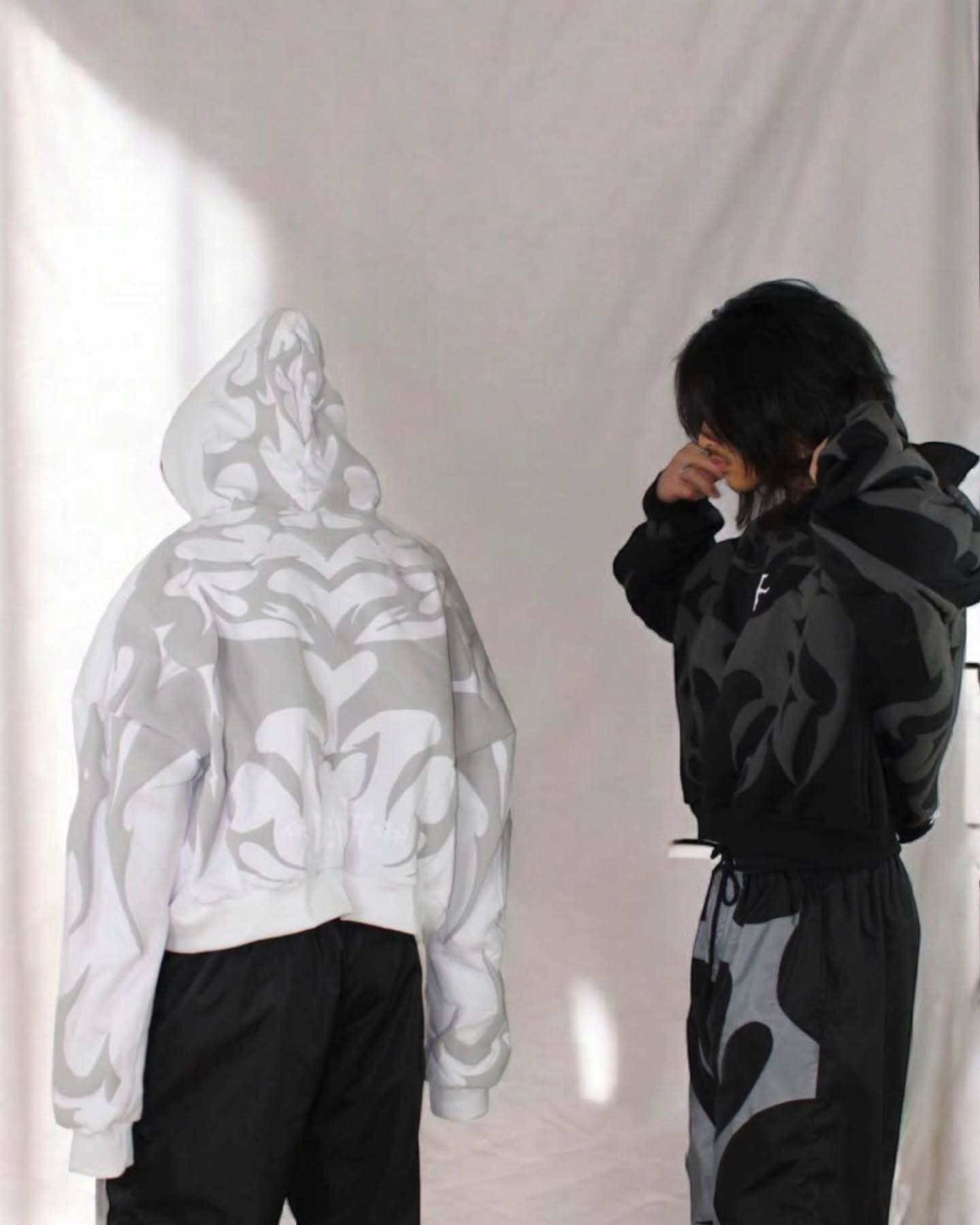 Model wearing oversized Gigavibe Depth Hoodie black & white for casual streetwear look