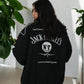 Women wearing a Jack Daniel’s jacket back design with bold whiskey branding indoors.