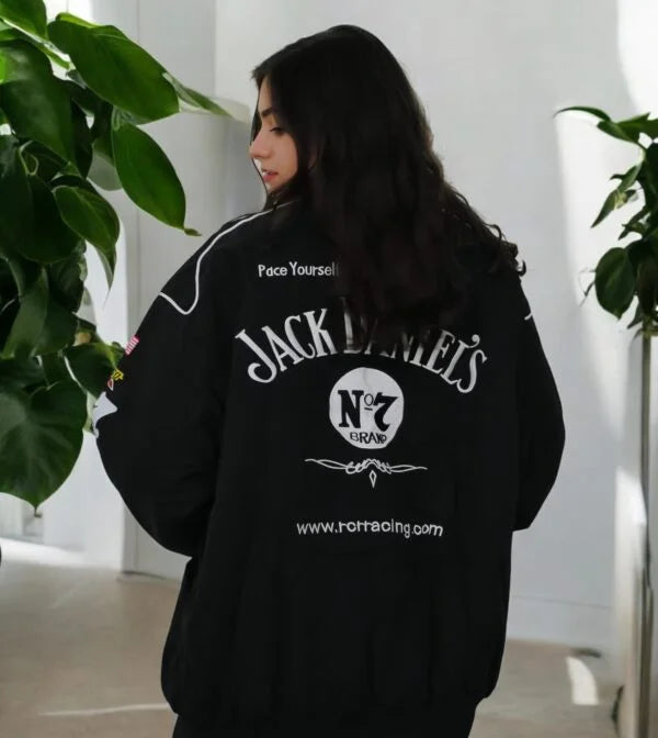 Women wearing a Jack Daniel’s jacket back design with bold whiskey branding indoors.
