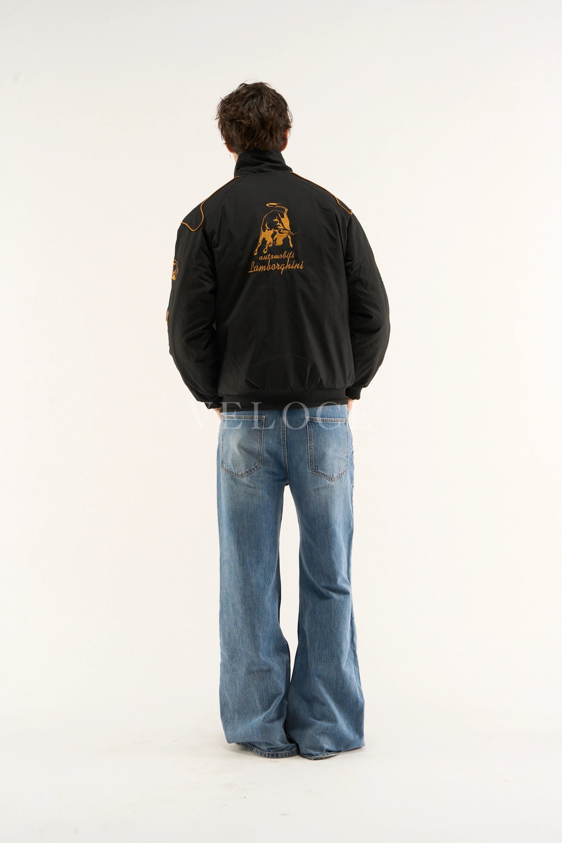Male model wearing a Back view of black Lamborghini jacket with stitched emblem
