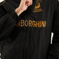 Close-up view of Gigavibe black Lamborghini jacket embroidered with gold logo and text on parachute fabric.