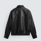Black leather jacket on a light gray background