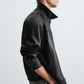 Man wearing a Gigavibe faux leather bomber jacket side profile streetwear style
