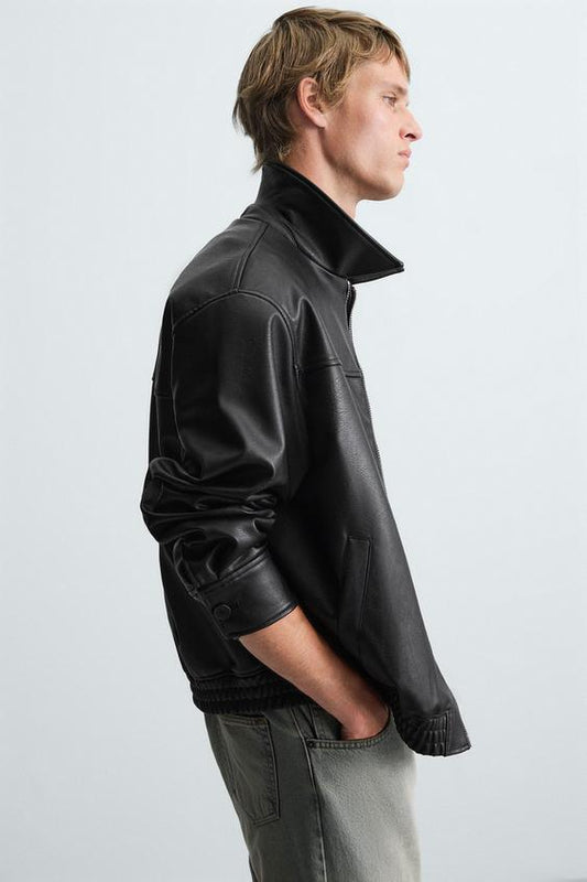 Man wearing a Gigavibe faux leather bomber jacket side profile streetwear style