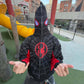 Model wearing black and red racing-inspired jacket with Ferrari-style logos and vintage patchwork