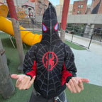 Model wearing black and red racing-inspired jacket with Ferrari-style logos and vintage patchwork