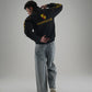 Man wearing Gigavibe Porsche Jacket Embroidered black racing jacket with yellow logo and text on back
