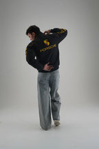 Man wearing Gigavibe Porsche Jacket Embroidered black racing jacket with yellow logo and text on back