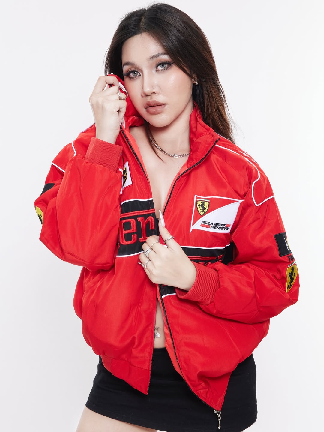 Model styling Gigavibe red Ferrari embroidered jacket zipped up with Ferrari racing embroidery.