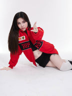 Model women wearing red F1 Ferrari jacket embroidered by Gigavibe, motorsport-inspired streetwear with Ferrari logo patches.
