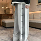 Black unisex trousers with straight cut and snap buttons