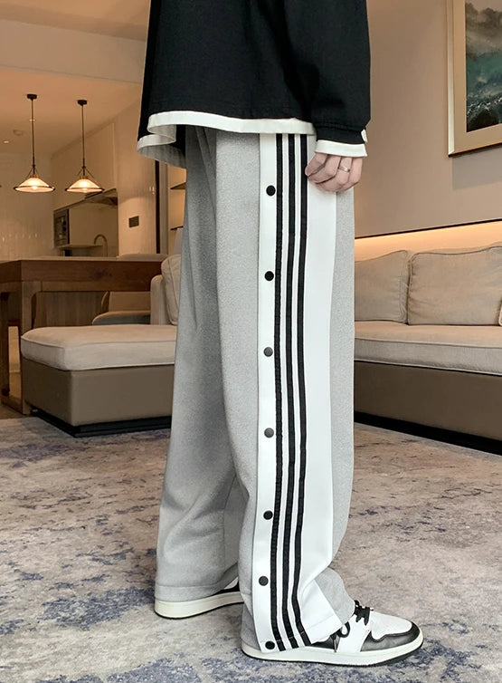 Black unisex trousers with straight cut and snap buttons