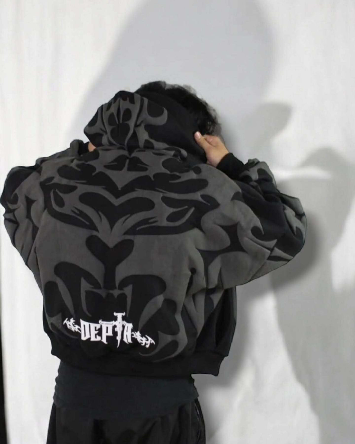 Back view of Gigavibe Tribal Depth Hoodie with bold puff printed artwork