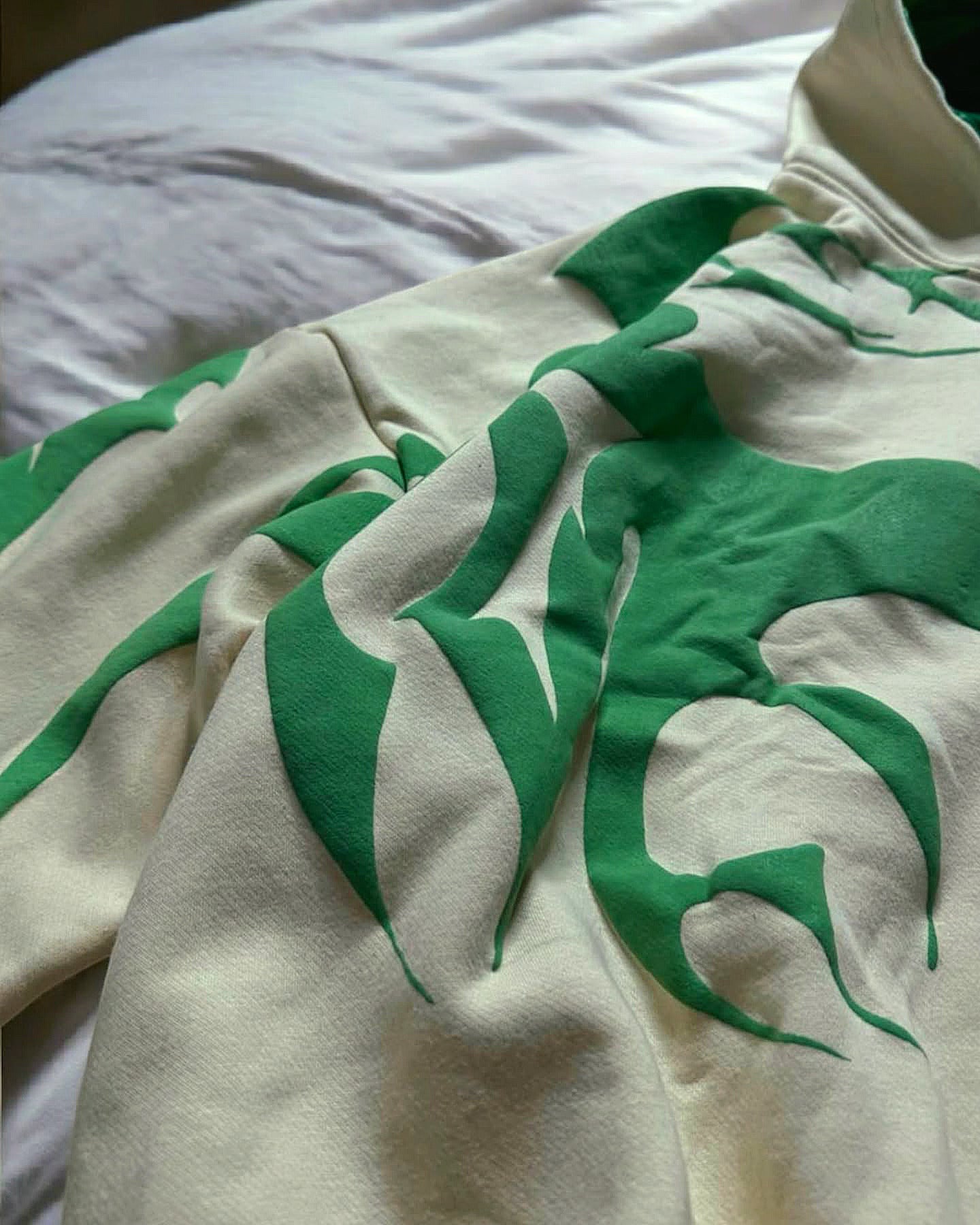 Unisex beige Depth Hoodie lifestyle shot outdoors in urban setting