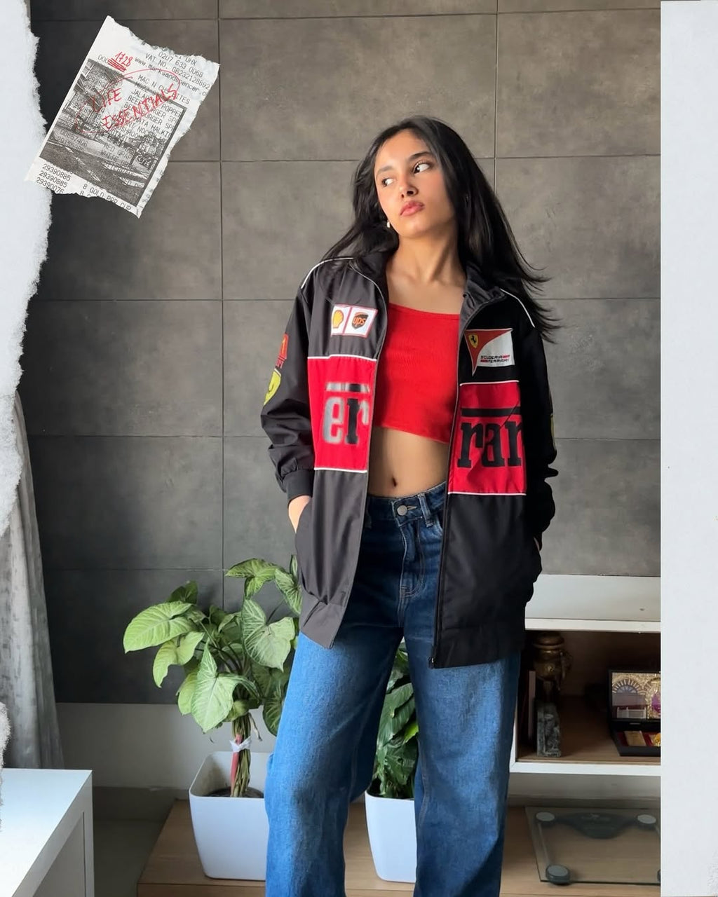 Model showcasing the black retro bomber jacket in a relaxed streetstyle pose. Highlights the jacket as the ultimate lightweight Scuderia merchandise streetwear style, worn effortlessly unzipped for summer aerodynamic airflow.