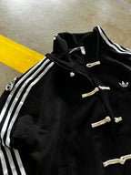Close up detail of traditional knot buttons on the Gigavibe Black CNY Jacket
