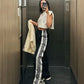 Unisex black streetwear pants with side snap buttons