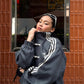 Lifestyle close-up of the female model wearing the brutalist Dark Grey variant. The stealth coloration and traditional toggle knots finalize this jacket as an absolute grail for women's darkwear fashion in India.