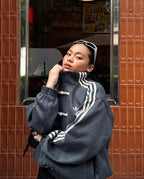 Lifestyle close-up of the female model wearing the brutalist Dark Grey variant. The stealth coloration and traditional toggle knots finalize this jacket as an absolute grail for women's darkwear fashion in India.