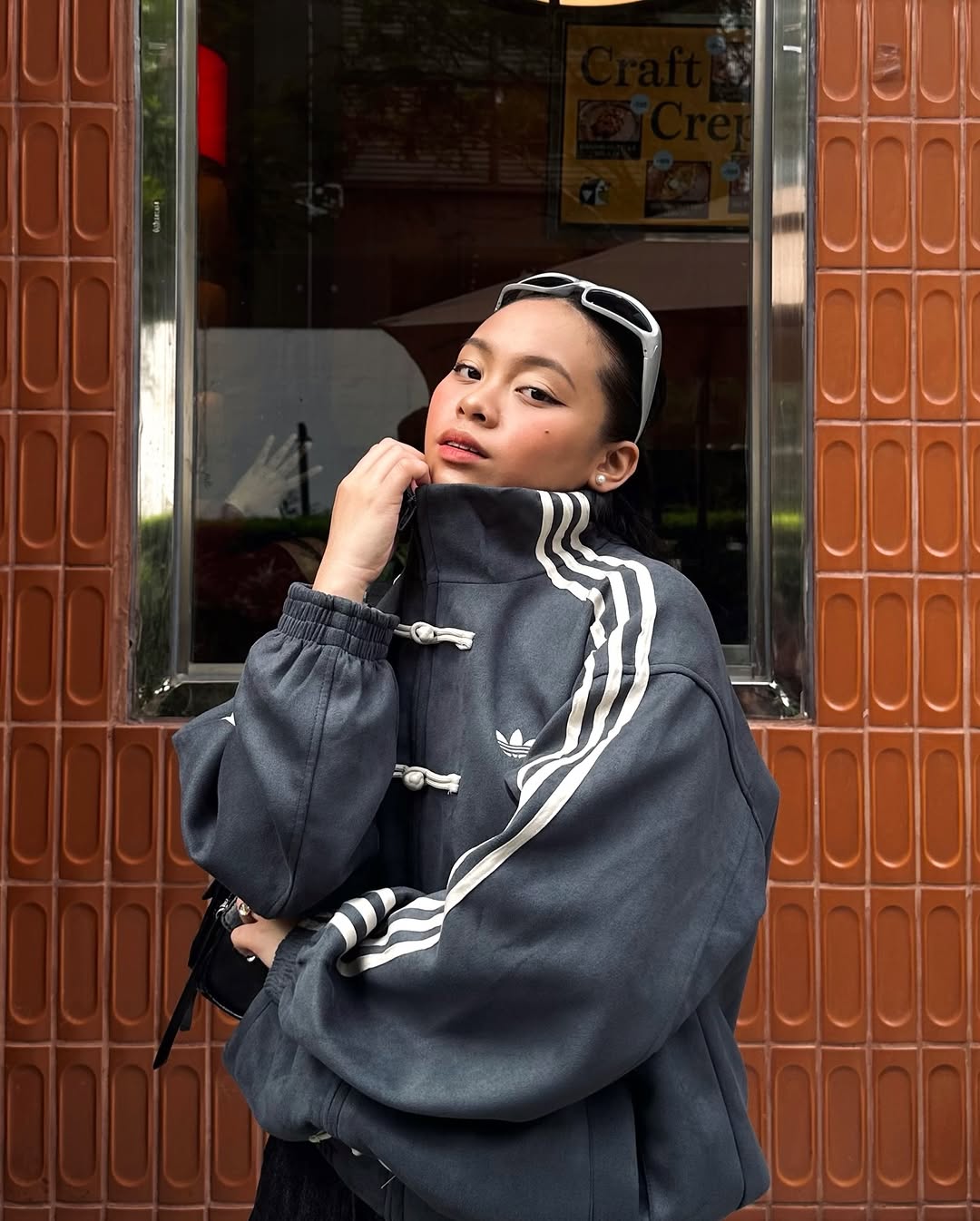 Lifestyle close-up of the female model wearing the brutalist Dark Grey variant. The stealth coloration and traditional toggle knots finalize this jacket as an absolute grail for women's darkwear fashion in India.