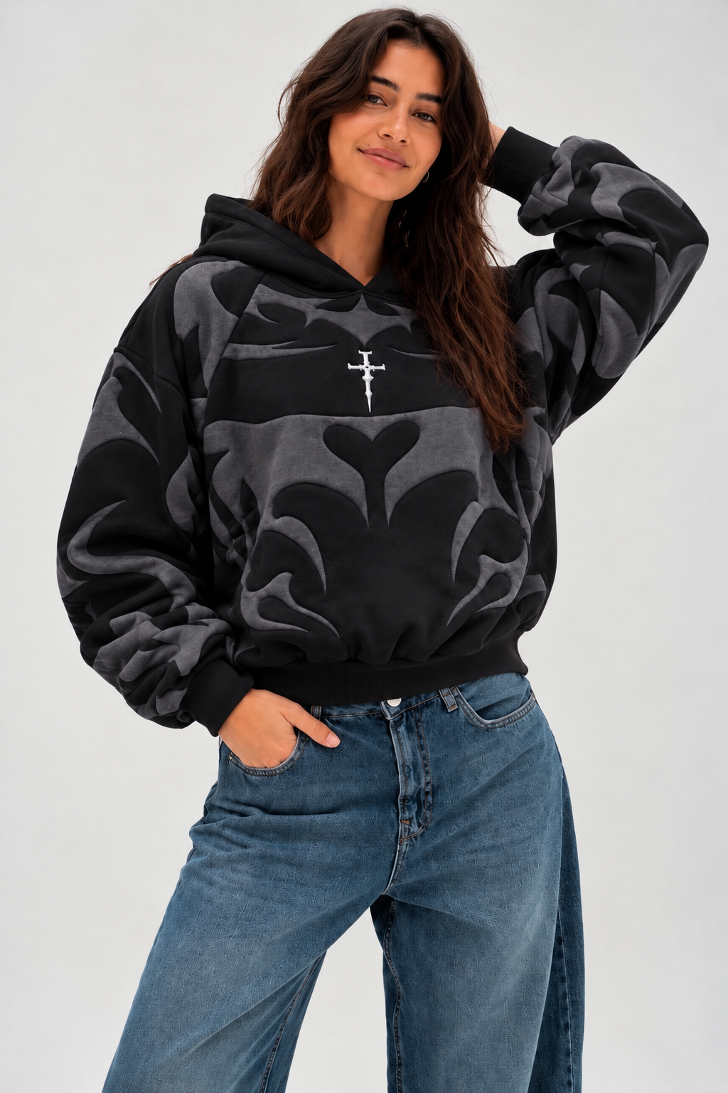 Front view of the girl wearing the heavyweight black hoodie, focusing on the spacious kangaroo utility pocket