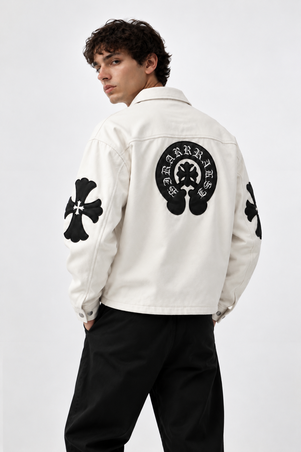 Back view of male model in the white Gigavibe jacket showing off the massive black leather horseshoe emblem and sleeve cross appliqués