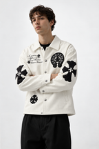 Male model rocking the Gigavibe Alabaster White Gothic cross patch faux leather jacket from the front, showcasing the boxy Y2K fit and spread collar