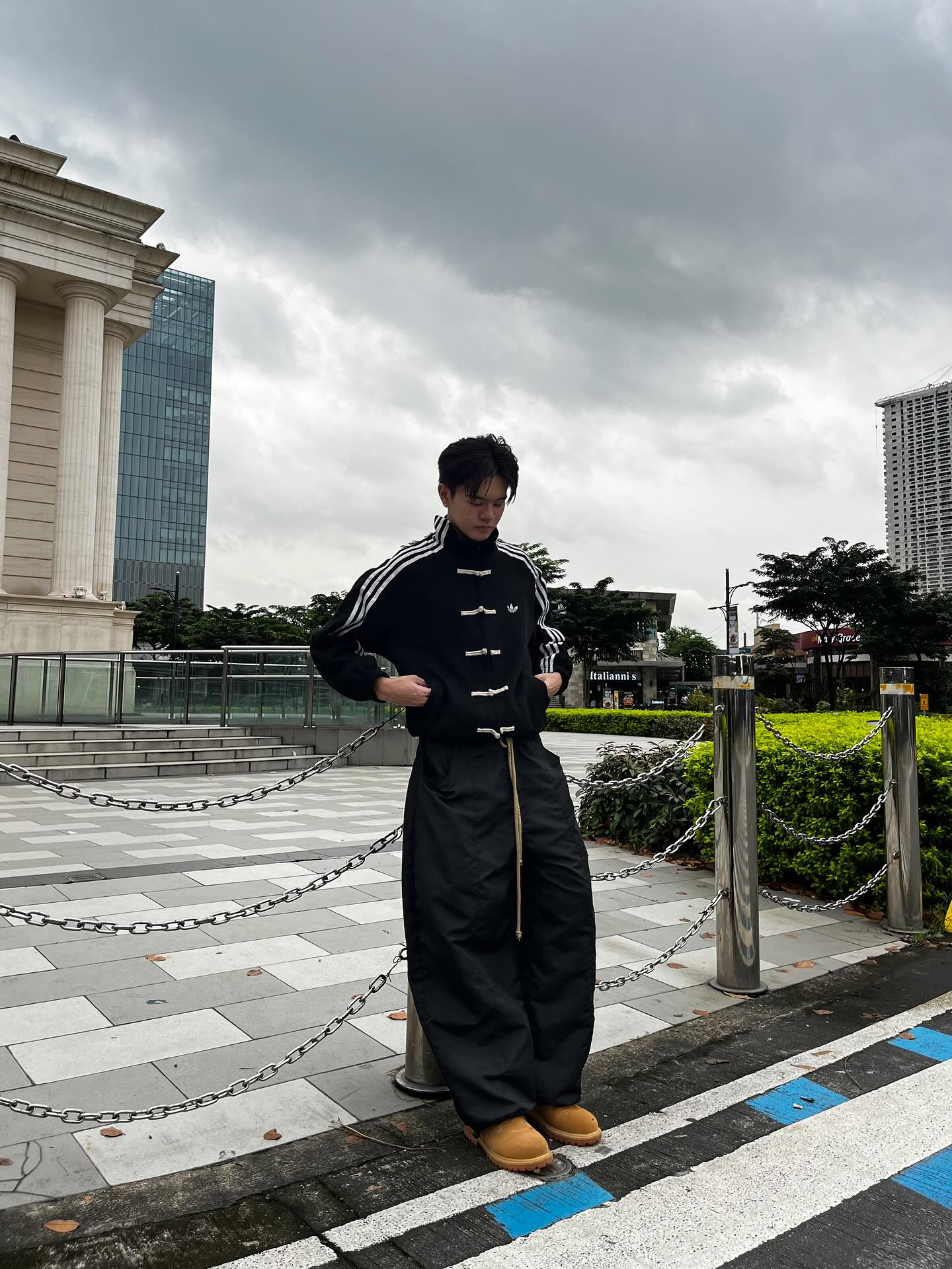 Male model wearing the Gigavibe Black Tang jacket with traditional knot closures