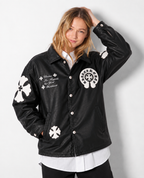 Front view of a Girl styling the black cross patch trucker jacket, showing the deep side welt pockets and silver snap fasteners