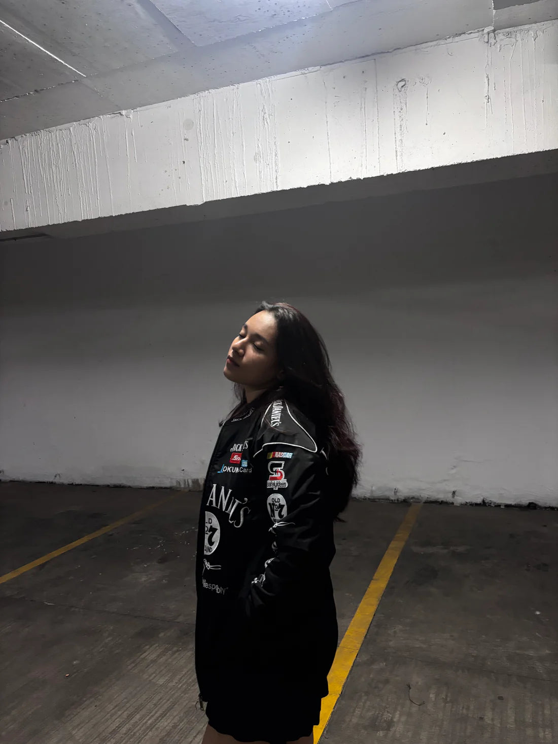 Side view of Jack Daniels embroidered racing jacket by Gigavibe, featuring motorsport-inspired patches and embroidery.