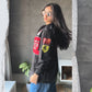 Side profile of the lightweight F1 motorcycle racing jacket showing the heavy F-1 Ferrari sleeve graphic. The model demonstrates the wide streetwear drape and drop-shoulder sleeve required for authentic Formula 1 clothing.