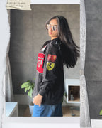 Side profile of the lightweight F1 motorcycle racing jacket showing the heavy F-1 Ferrari sleeve graphic. The model demonstrates the wide streetwear drape and drop-shoulder sleeve required for authentic Formula 1 clothing.